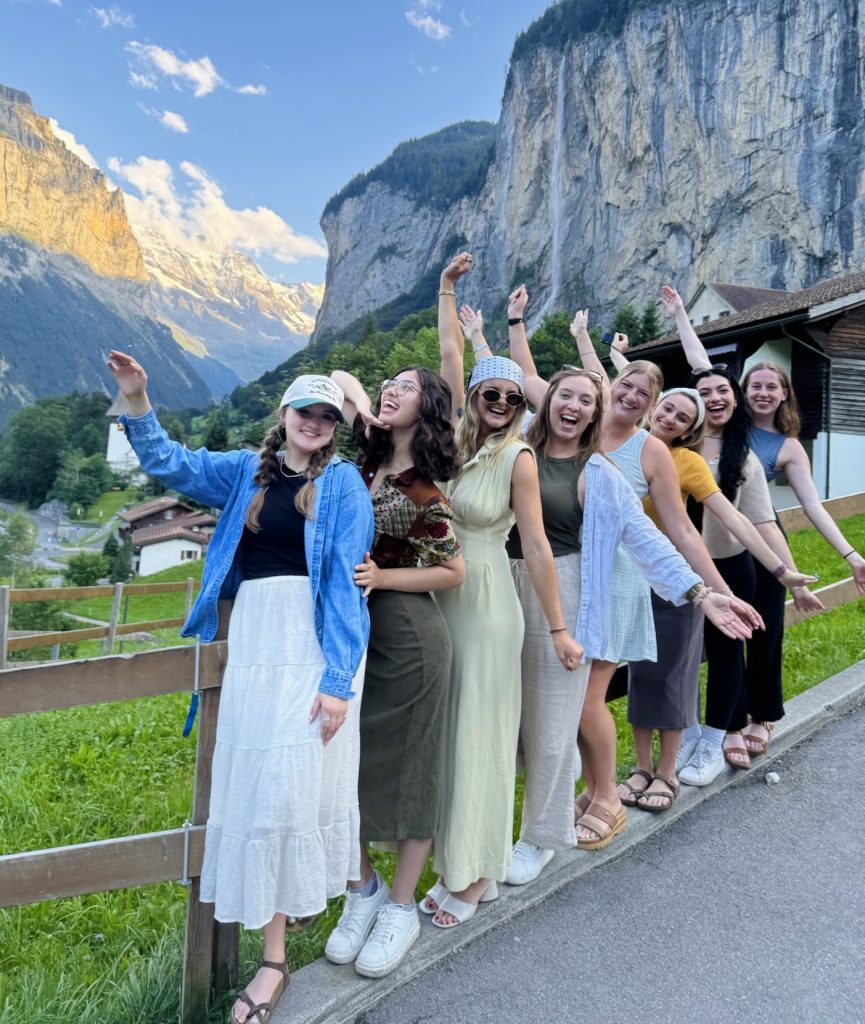 Group of women on a guided trip smiling in Lauterbrunnen Valley in Switzerland
